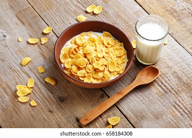 Cornflakes cereal and milk in a clay bowl. Morning breakfast.
