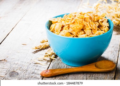 cornflakes on wooden table at morning