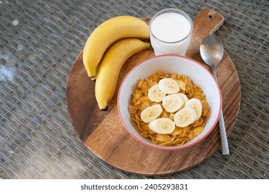 Cornflakes topping with banana  with milk in bowl placed Ready to eat for breakfast or before workout. Healthy food. - Powered by Shutterstock