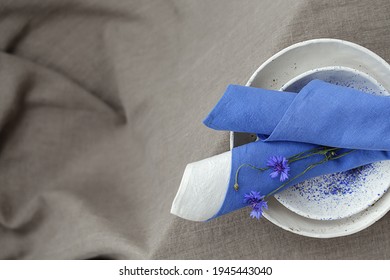 Cornflower And Blue Linen Napkin On Rustic Style Decorated Table