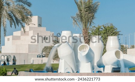 Corniche in Doha with the water pots fountain landmark timelapse, with the distant business towers skyline. Islamic museum is in the background.