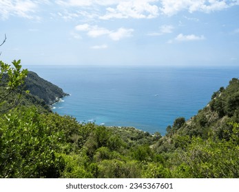 Corniglia, Italy -  July 03 2023: Cinque Terre National Park seen from the hiking trail. The Cinque Terre comprises five villages: Monterosso al Mare, Vernazza, Corniglia, Manarola, and Riomaggiore.