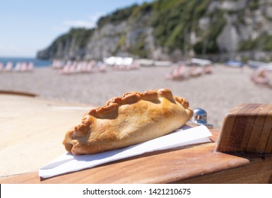 Cornish pasty on beach location - Shutterstock ID 1421210675
