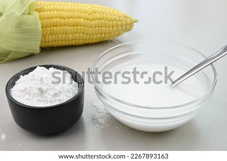 Cornstarch water in a bowl, used in cooking for thickening sauce.