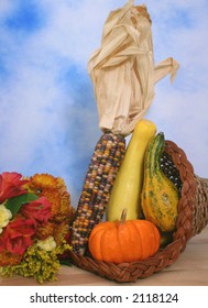 Cornucopia With Fall Vegetables and Flowers on Blue and White Background