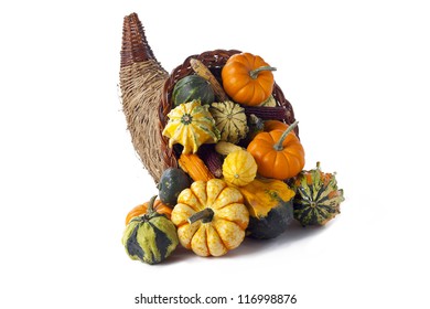 Cornucopia of gourds on white.