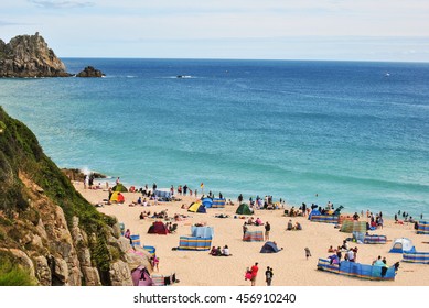 CORNWALL, ENGLAND- July 22, 2015: busy Porthcurno Beach in the lovely summer day, minutes walk from Minack Theater 