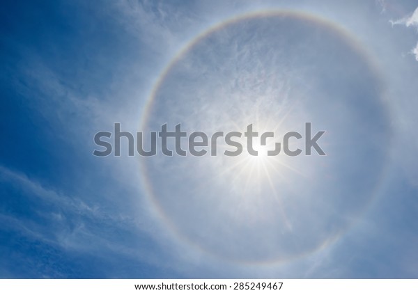 Corona ring around the\
sun on blue sky