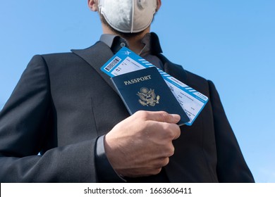 Corona Virus. Air Traveler Business Man Wearing Face Masks Walk Through The Airport. Business Man Wear Mask To Protect And Take Care Of Their Health From Virus. Travel Safety. Passport. Boarding Pass.