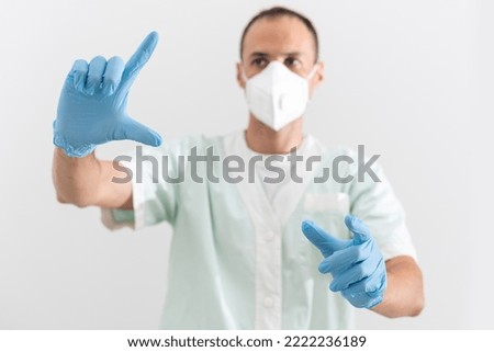 corona virus concept. male scientist doctor in professional respirator, glasses, latex gloves and protective suit getting ready for COVID-19 pandemic outbreak quarantine.