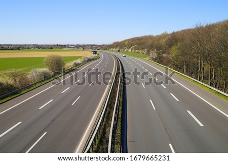 Corona virus crisis stay at home and curfew shutdown concept: no traffic on deserted empty german highway A61 between Germany and Netherlands to border crossing