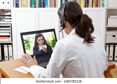 Corona-Virus-Hotline: Arzt mit Kopfhörer während eines Videos konsultieren Sie einen Patienten mit Erkältung.