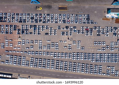 Corona Virus Lockdown, Rows Of New Cars On Hold Due To Government Guidelines Impacting The Shipping And Auto Industry, Top Down Aerial View.