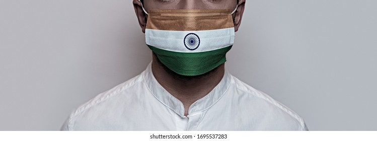 Corona virus pandemic. Concept of Corona virus quarantine, Covid-19. The male face is covered with a protective medical mask, painted in India flag colors - Powered by Shutterstock