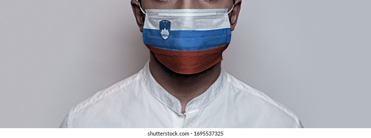 Corona Virus Pandemic. Concept Of Corona Virus Quarantine, Covid-19. The Male Face Is Covered With A Protective Medical Mask, Painted In Slovenia Flag Colors