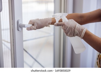 Corona Virus Prevention, Cleaning Woman Wiping Doorknob With Antibacterial Cleanser For Killing Coronavirus On Touching Surfaces.