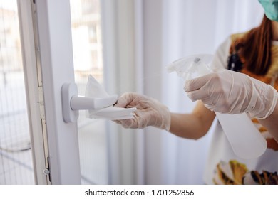 Corona Virus Prevention, Cleaning Woman Wiping Doorknob With Antibacterial Cleanser For Killing Coronavirus On Touching Surfaces.