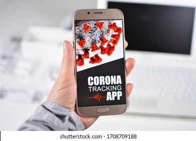 Corona Virus Tracking App concept with hand holding cell phone with application design on screen in front of blurry office background - Shutterstock ID 1708709188