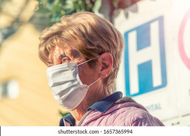 Coronavirus Alarm In Italy, Europe. Elderly Woman At ER Hospital Entrance Wearing Respirator Mask. New Type 2019-nCoV Pneumonia In Italy Has Been Spreading In Many Cities.