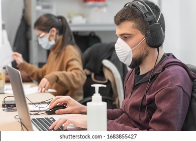 Coronavirus. Business workers working from home wearing protective mask. Small company in quarantine for coronavirus working from home with sanitizer gel. Small company concept. - Shutterstock ID 1683855427