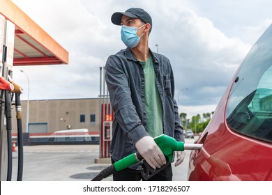 Coronavirus. Car Refueling On Petrol Station. Man With Face Mask Pumping Gasoline Oil During Quarantine. Automotive Industry Or Transportation And Ownership Concept. Delivery Service Concept. Isolated