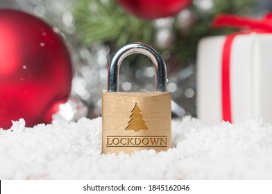 Coronavirus Christmas Lockdown: A Lock On The Snow Surrounded By Red And Green Christmas Decorations