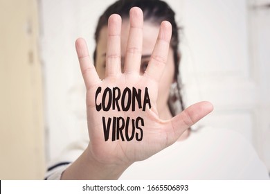 coronavirus concept painted in the palm of a young caucasian woman - Shutterstock ID 1665506893