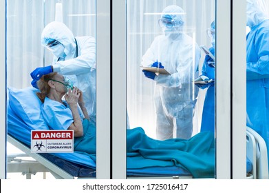 Coronavirus Covid 19 Disease Doctor Put Air Ventilator For Infested Coronavirus Covid 19 Patient With A Team Monitoring The Symptom In Clean Quarantine Room With Danger Outbreak Alert Sign 