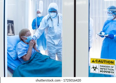 Coronavirus Covid 19 Disease Expert Monitors Infested Coronavirus Covid 19 Patient With Dry Cough Symptom In Clean Quarantine With A Nurse Holding Ditigal Themometer With Danger Sign