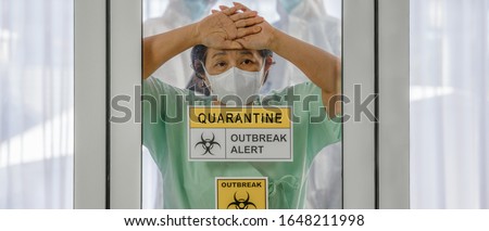 coronavirus covid 19 infected patient in coronavirus covid 19 quarantine room with quarantine and outbreak alert sign at hospital with blurred disease control experts, coronavirus outbreak control
