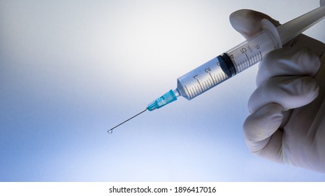 Coronavirus (COVID 19) Vaccine and syringe injection.
Close up vaccination vial dose flu shot drug needle syringe.  - Shutterstock ID 1896417016