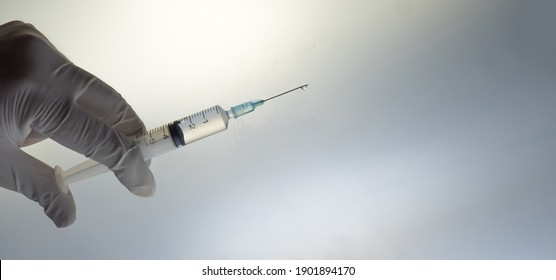 Coronavirus (COVID 19) Vaccine And Syringe Injection. Close Up Vaccination Vial Dose Flu Shot Drug Needle Syringe.  Copy Space.