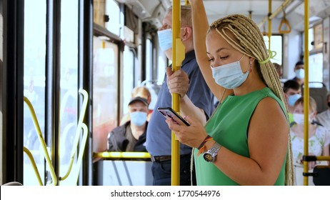 Coronavirus, Covid -19, Young Woman With Respiratory Mask Traveling In The Public Transport By Bus
