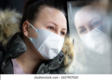 Coronavirus, Covid 2019, Young Woman With Respiratory Mask Traveling In The Public Transport By Bus