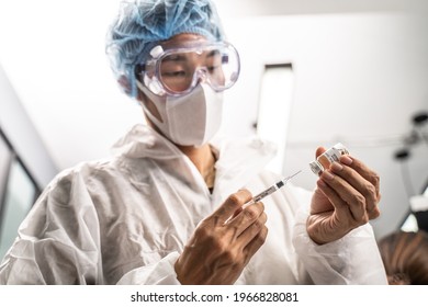 The Coronavirus Or COVID Vaccine In Hands Of Pharmaceutical Bio Research And Development Scientist Team. The Researcher Work In Laboratory Room Of Covid-19 Vaccine And Drug Manufacturing Company.