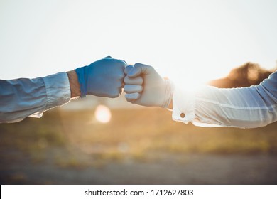 Coronavirus or covid-19 bacteria spread by handshake or touch concept. Say No to Handshake. Businessman handshake and virus spread. Doctors holding hands together as colleagues wearing black gloves. - Powered by Shutterstock