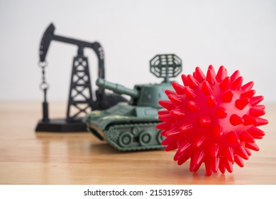 Coronavirus (covid-19), Battle Tank Model And Crude Oil Pumpjack On Wooden Table Background. Concept Of Global World Economy Crisis Due To Energy Cost Price Increase, Coronavirus Pandemic And War.