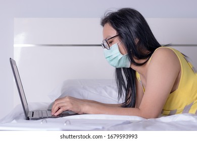 Coronavirus Or Covid-19, Business Woman Working From Home Wearing Protective Mask. Business Woman In Quarantine For Coronavirus Wearing Protective Mask. Working From Home. Business Continuity Plan.