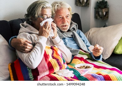 Coronavirus CoVid-19 Couple Old Aged Senior People At Home With Seasonal Winter Cold Illness Disease  Sit Down On The Sof Together Forever - Health Problems For Retired Man And Woman With White Hair