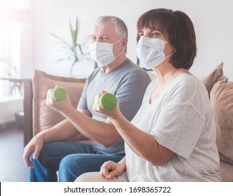 Coronavirus CoVid-19 Couple Old Aged Senior People At Home With Seasonal Cold Illness Disease Doing Exercise. Elderly Couple In Medical Masks During The Pandemic Sport