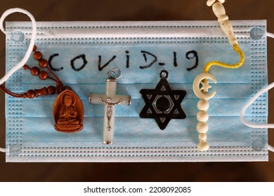 Coronavirus (COVID-19)  Epidemic.  Interreligious Symbols On A Medical Mask. Buddhism, Christianity, Islam, And Judaism.   