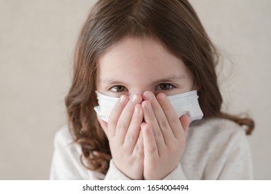 Coronavirus COVID-19 Epidemic Outbreak Quarantine Concept Of Small Kid In Medical Mask Wants To Sneeze