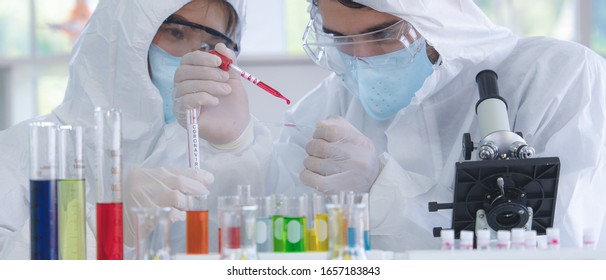 Coronavirus Covid-19 Infected Blood Sample In Sample Tube On Hand Of Scientist In Biohazard Protection Clothing Doing Analysis To Coronavirus Covid 19 Sample In Laboratory