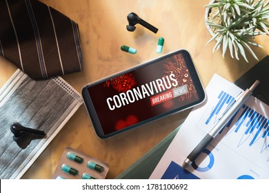 Coronavirus Or Covid-19 Outbreak Breaking News Update Background Concept. Mockup Mobile Phone With Facial Masks And Medical Tablets On Businessman's Office Wood Desk Table.