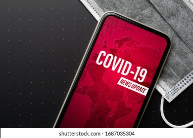 Coronavirus Or Covid-19 Outbreak News Update Background Concept. Mockup Mobile Phone Coronavirus News With Facial Masks. Flat Lay Top View With Copy Space.