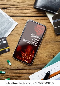 Coronavirus Covid-19 Pandemic Outbreak Crisis Management Background Concept. Mockup Mobile Phone On Grunge Wood With  Business Charts, Facemask On Working Table.