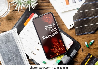 Coronavirus Covid-19 Pandemic Outbreak Crisis Management Background Concept. Mockup Mobile Phone On Grunge Wood With  Business Charts, Facemask On Working Table.