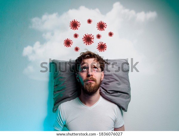 Coronavirus, covid-19 phobia,\
fear of pandemics. Man laying in bad and thinking about danger of a\
virus 