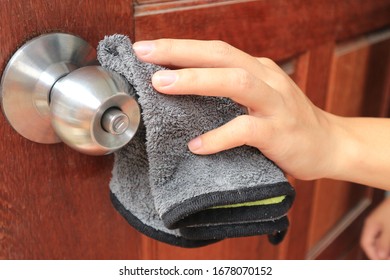                                Coronavirus COVID-19 Prevention Cleaning Woman Wiping Doorknob
.