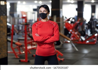 Coronavirus covid-19 prevention, fitness girl with a medical mask posing in gym. Fighting viruses. - Powered by Shutterstock